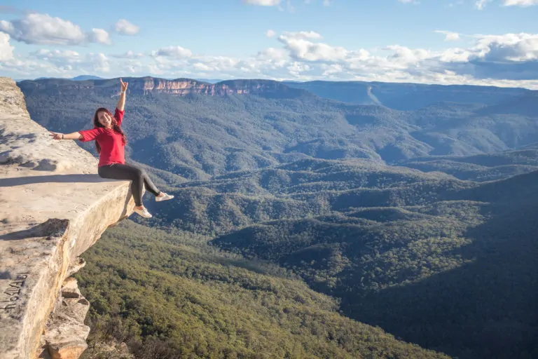 Girl sitting on the edge of a cliff in the Blue Mountains outside of Sydney, Australia