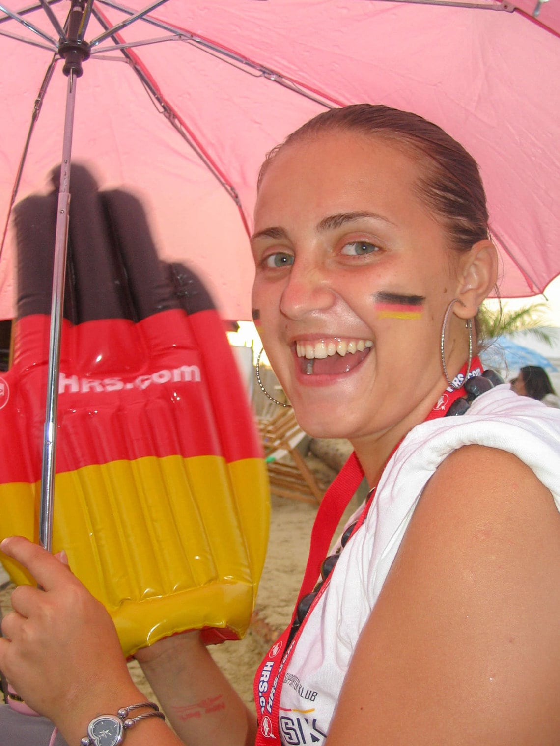 Girl cheering for Germany at the 2006 World Cup in Berlin, with Germany flag stickers on her cheeks.