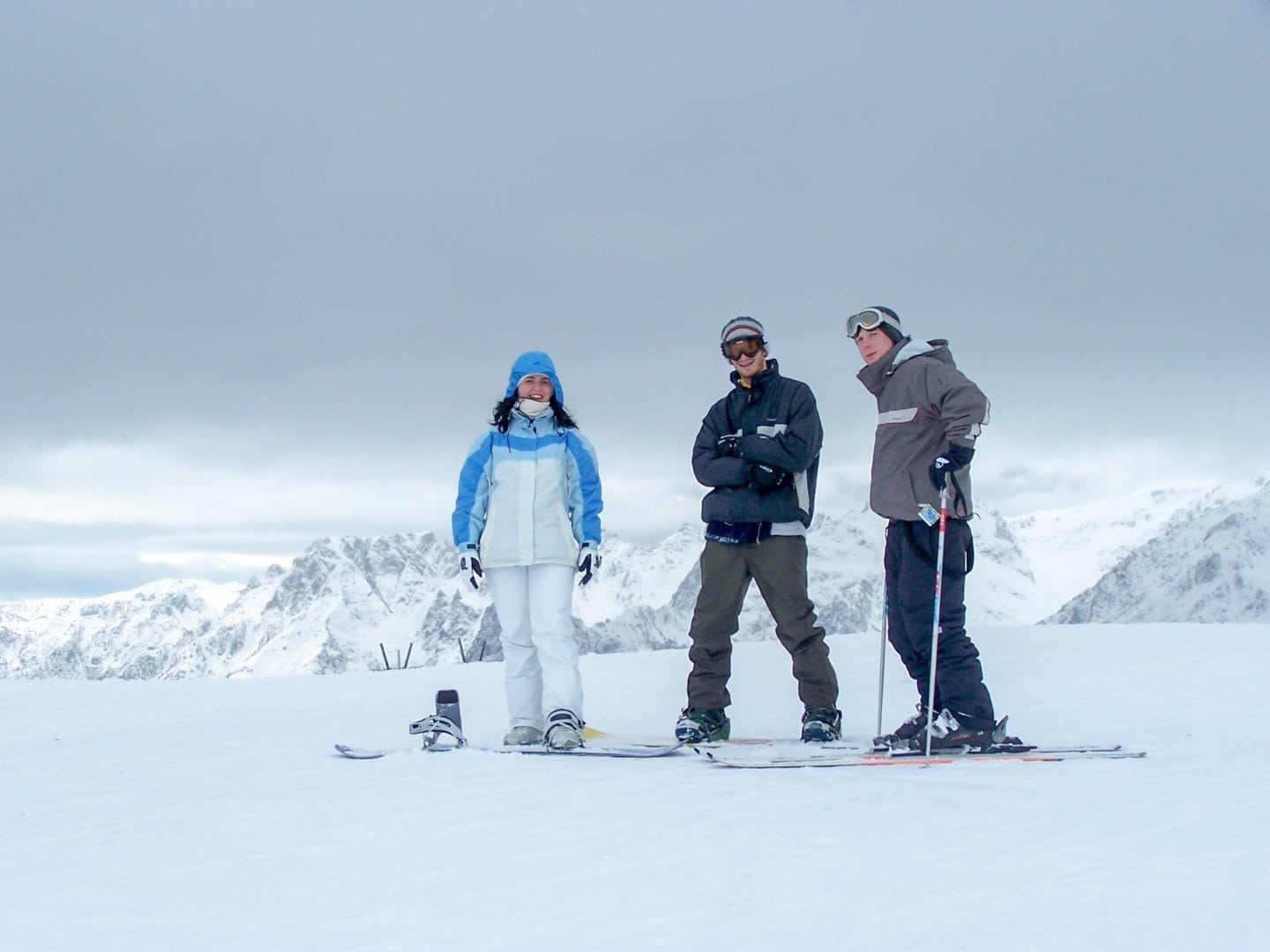 Three friends snowboarding in the Alps in France (Rhone Alps region).