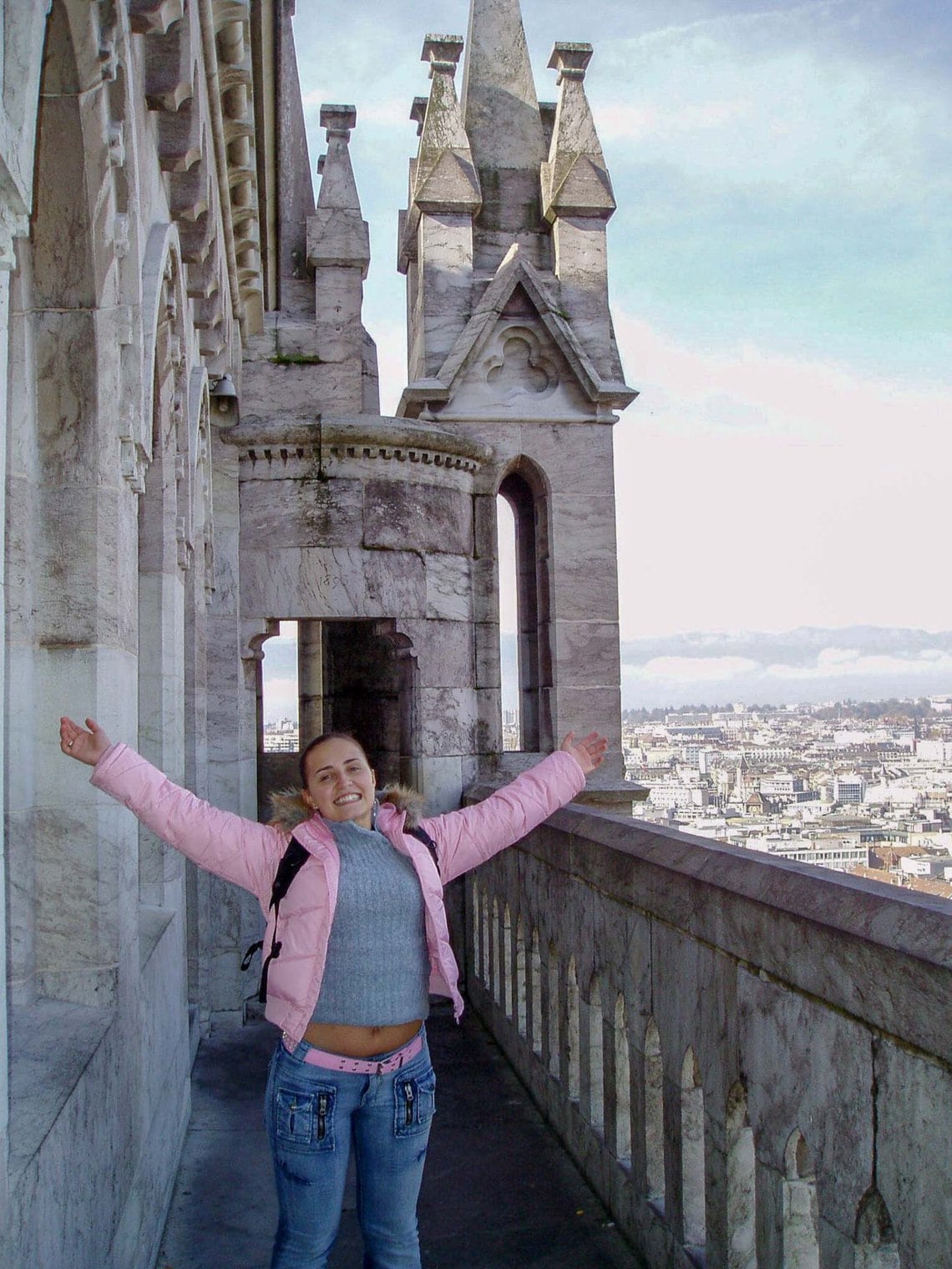 Girl on a balcony on top of a church in Geneva, Switzerland.