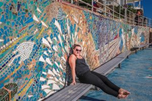 girl sitting on bench at Bondi Beach