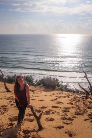 girl on a sand dune at sunrise