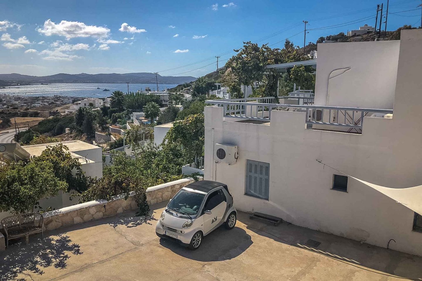a car parked next to Hotel Agnanti in Milos