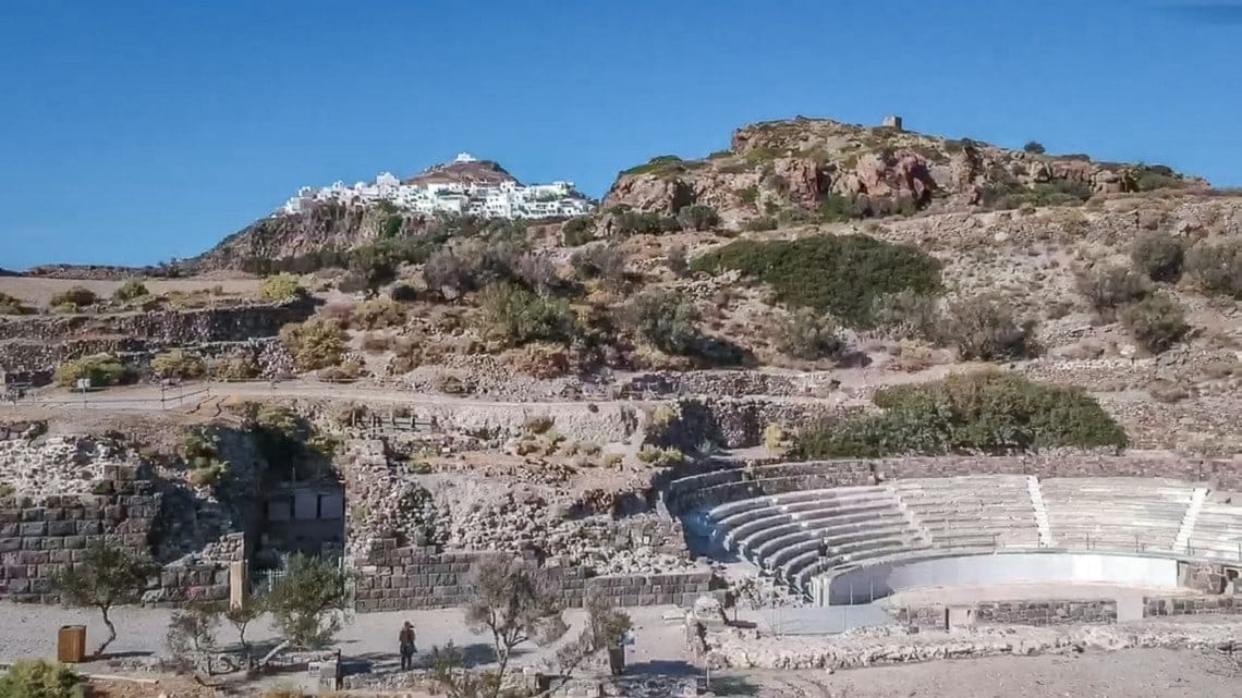 drone shot of the ancient amphitheatre with Plaka village perched on top