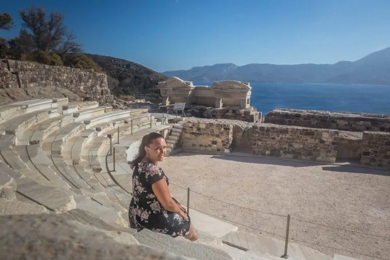 girl on theatre steps overlooking the sea