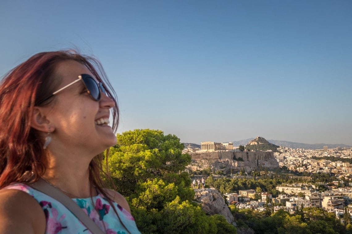 girl on top of a hill with Acropolis in the background