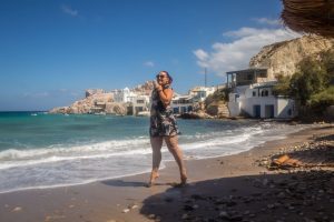 girl jumping on Firopotamos beach on the north side of Milos island