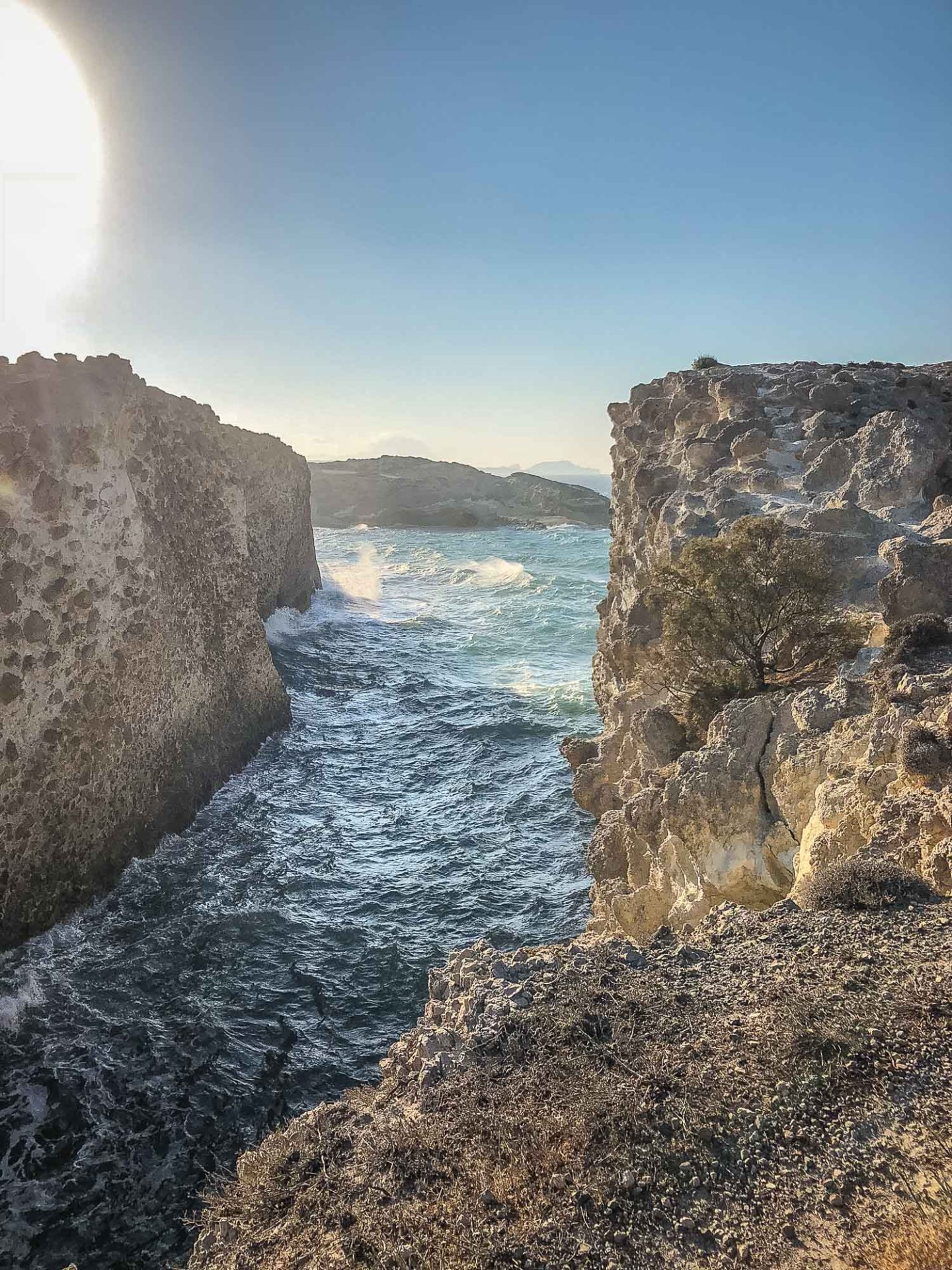 wave crashing between the rocks at sunset