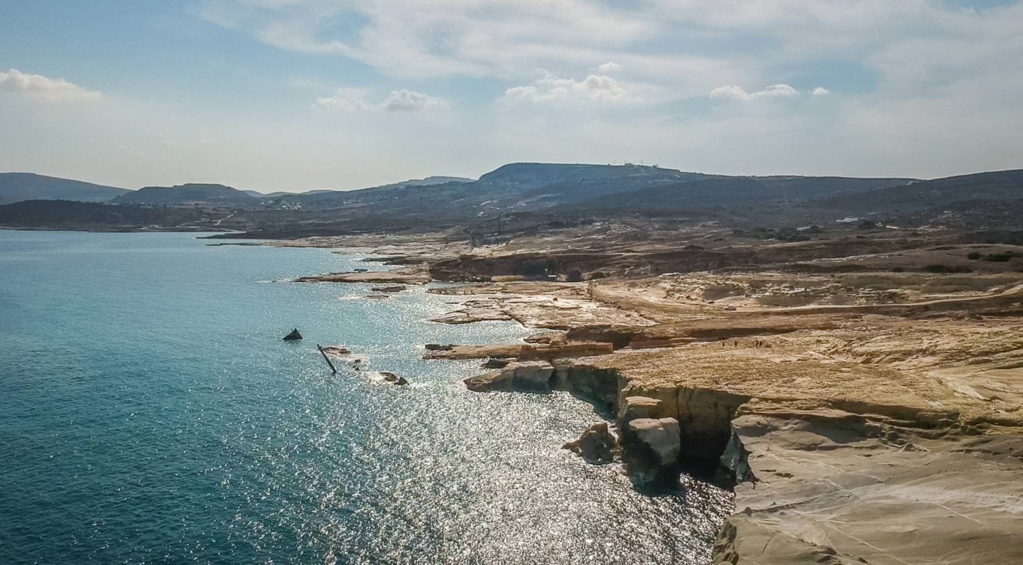 rugged rocks line the northern coast of Milos along the Aegean Sea