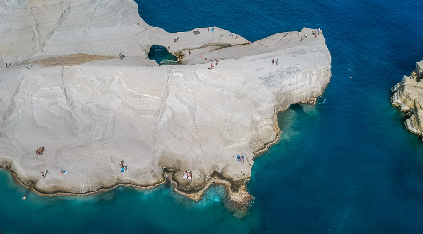 drone shot of rock formations in Milos