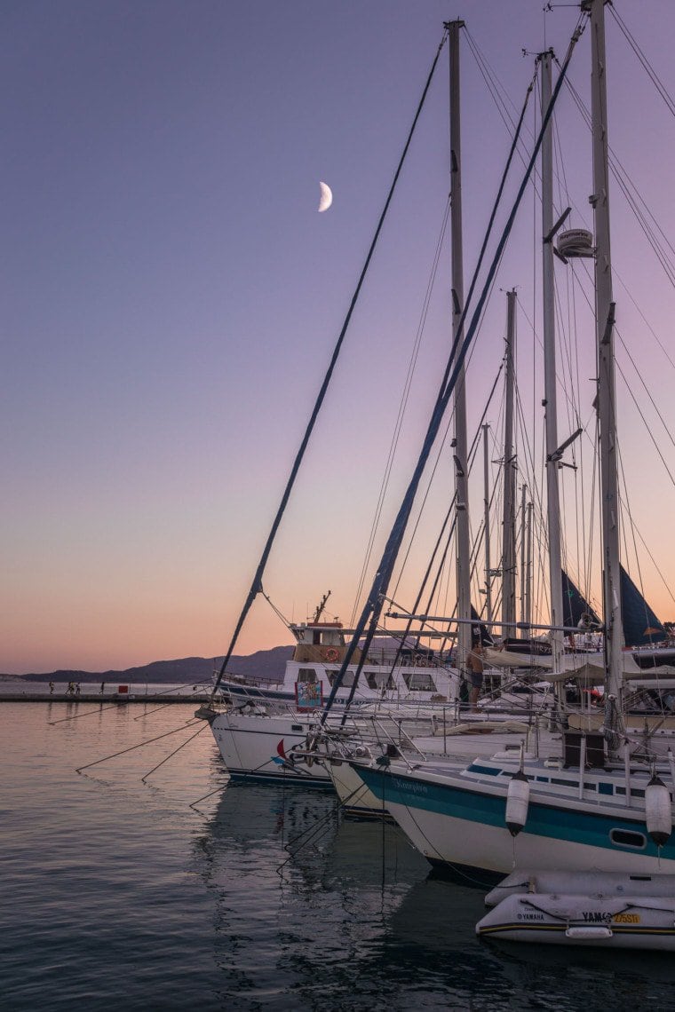 boats in harbour during sunset in Milos