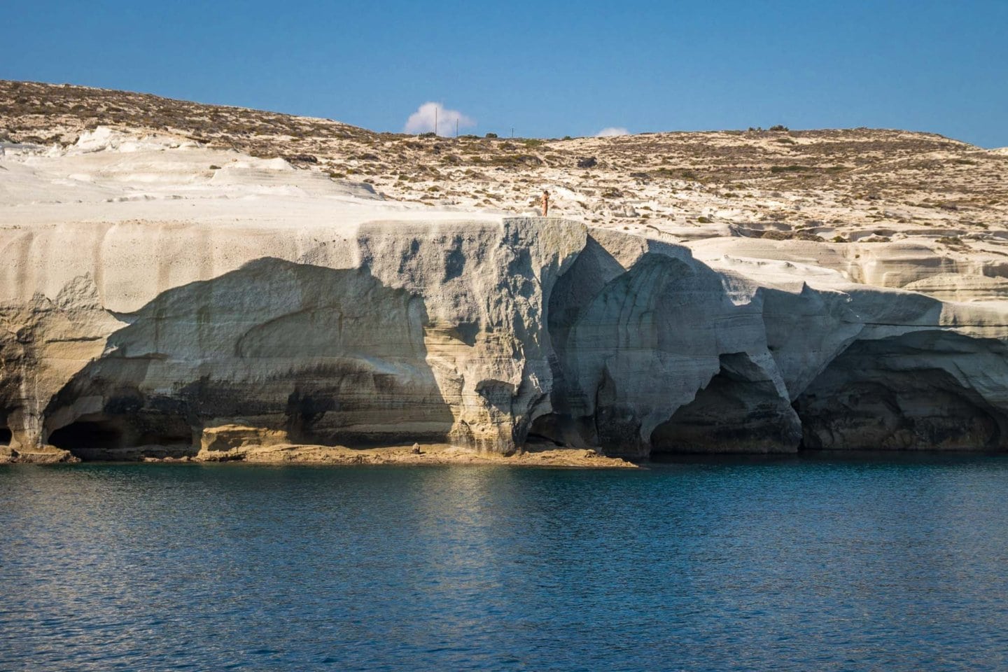 Milos caves seen in passing from a sailing boat.