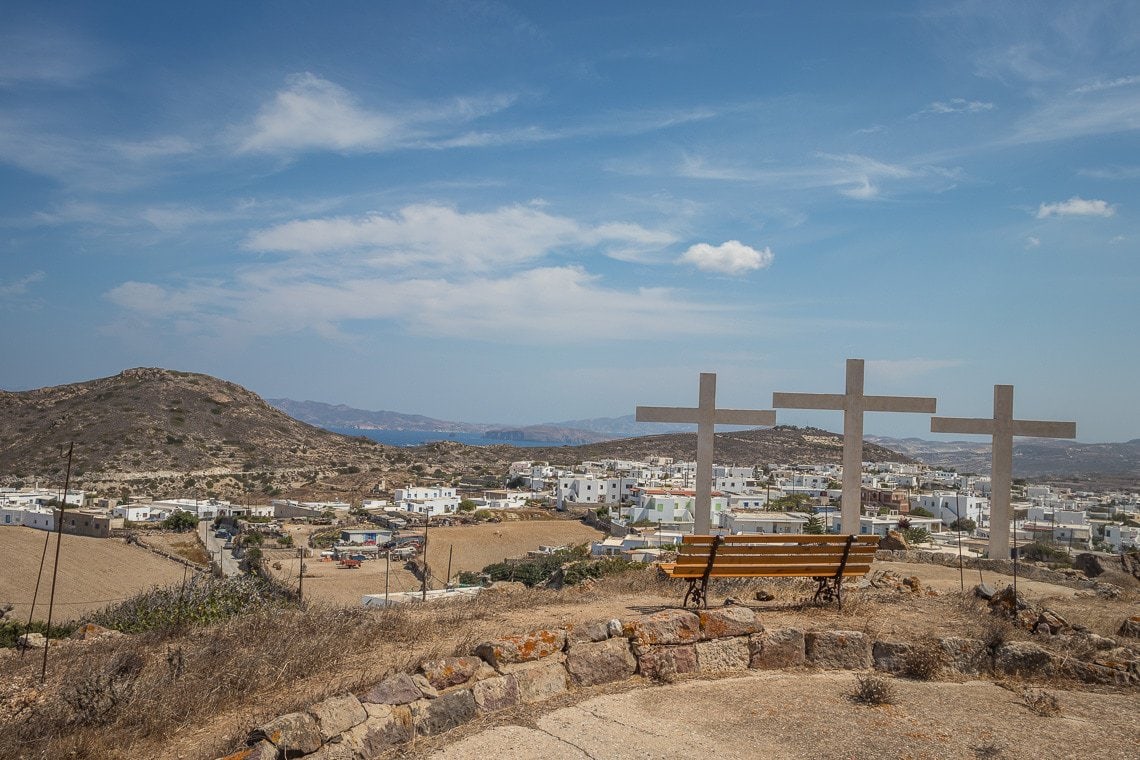 three crosses monument on top of a hill in Milos, overlooking Plakes village