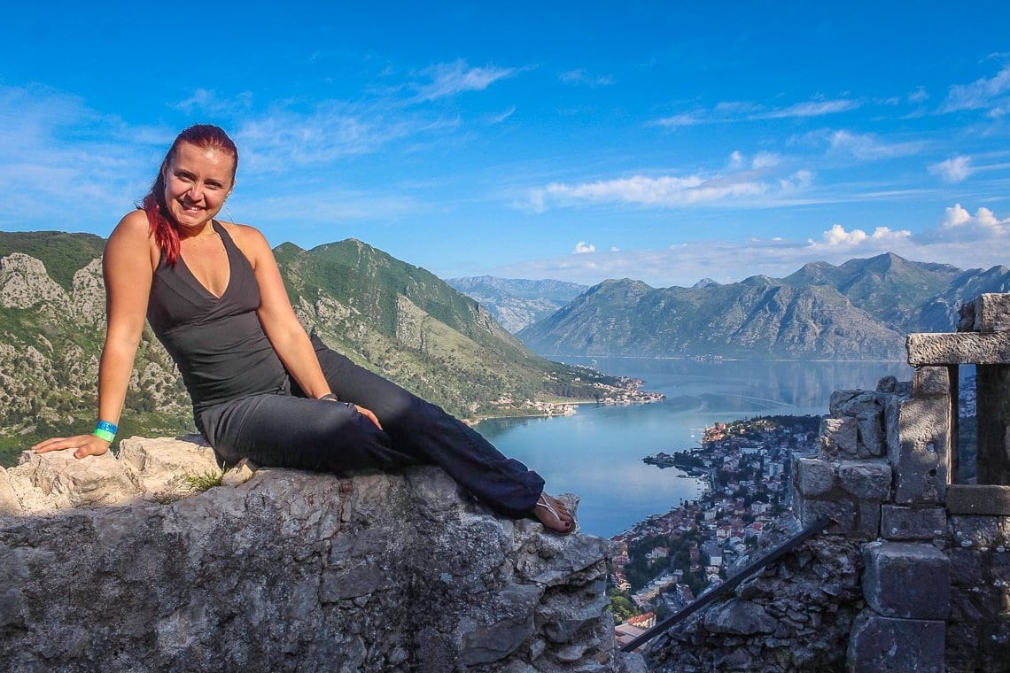 Woman on a fortress wall above the Bay of Kotor in Montenegro.