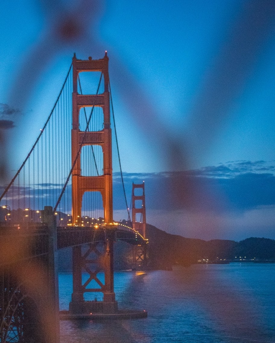 San Francisco bridge seen through a fence after sunset