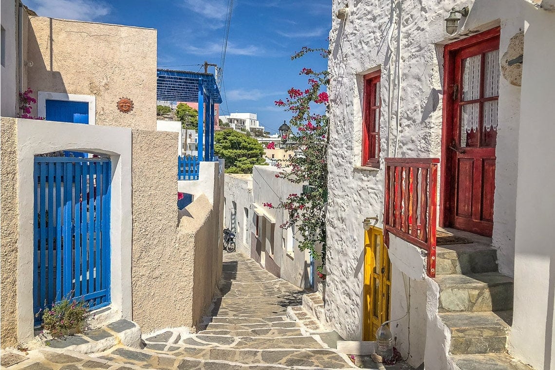 White house with a red door in Plaka on the island of Milos.