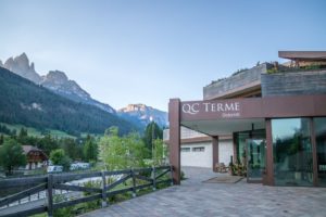 the entrance to QC Terme Dolomiti with a backdrop of Dolomite mountains