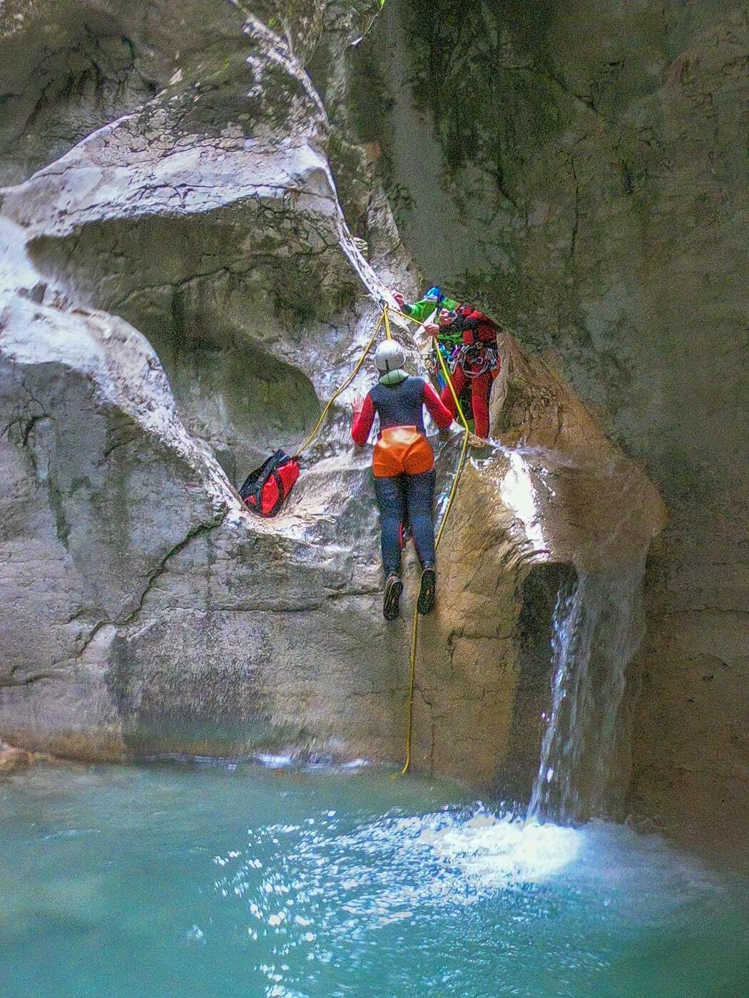 woman being slid down a canyon in trentino