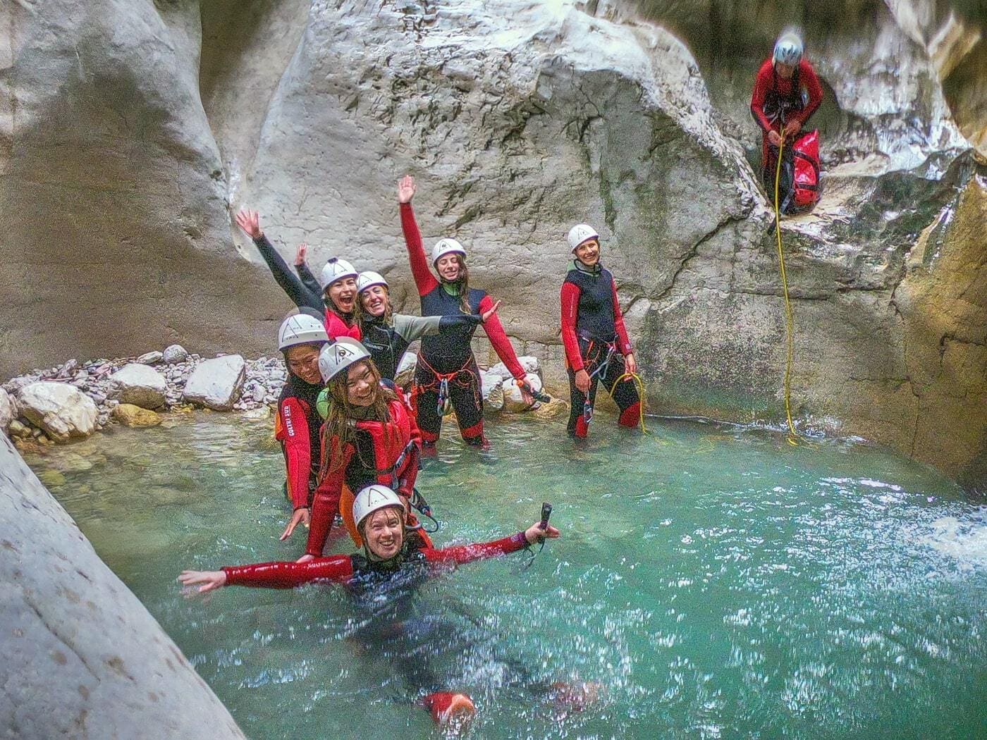 group of adventure girls in a canyon pool in trentino