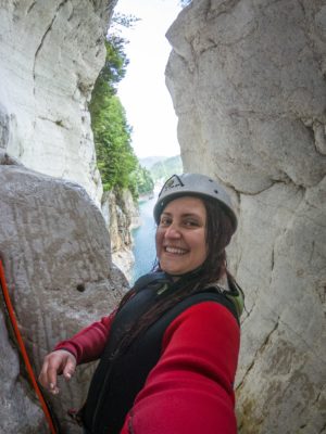 woman canyoning with noana lake behind her