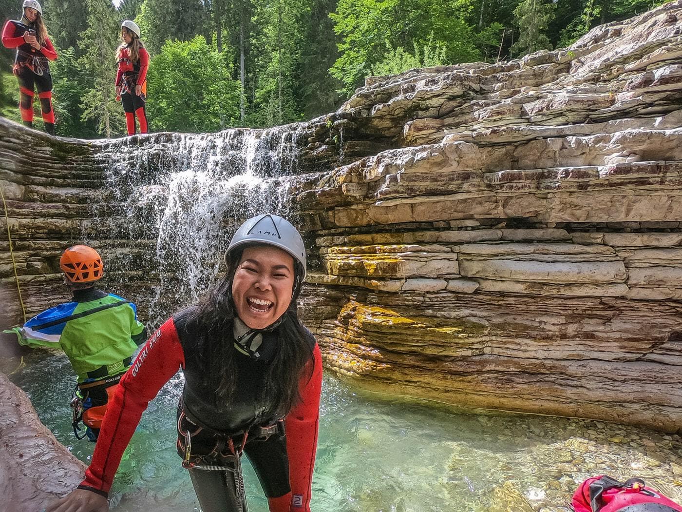 woman laughing after descending into a canyon in val noana trentino