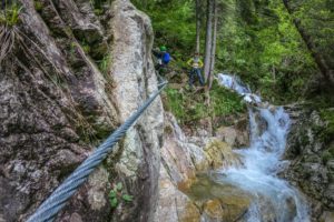 steel rope and a waterfall during ferrata val di scala route