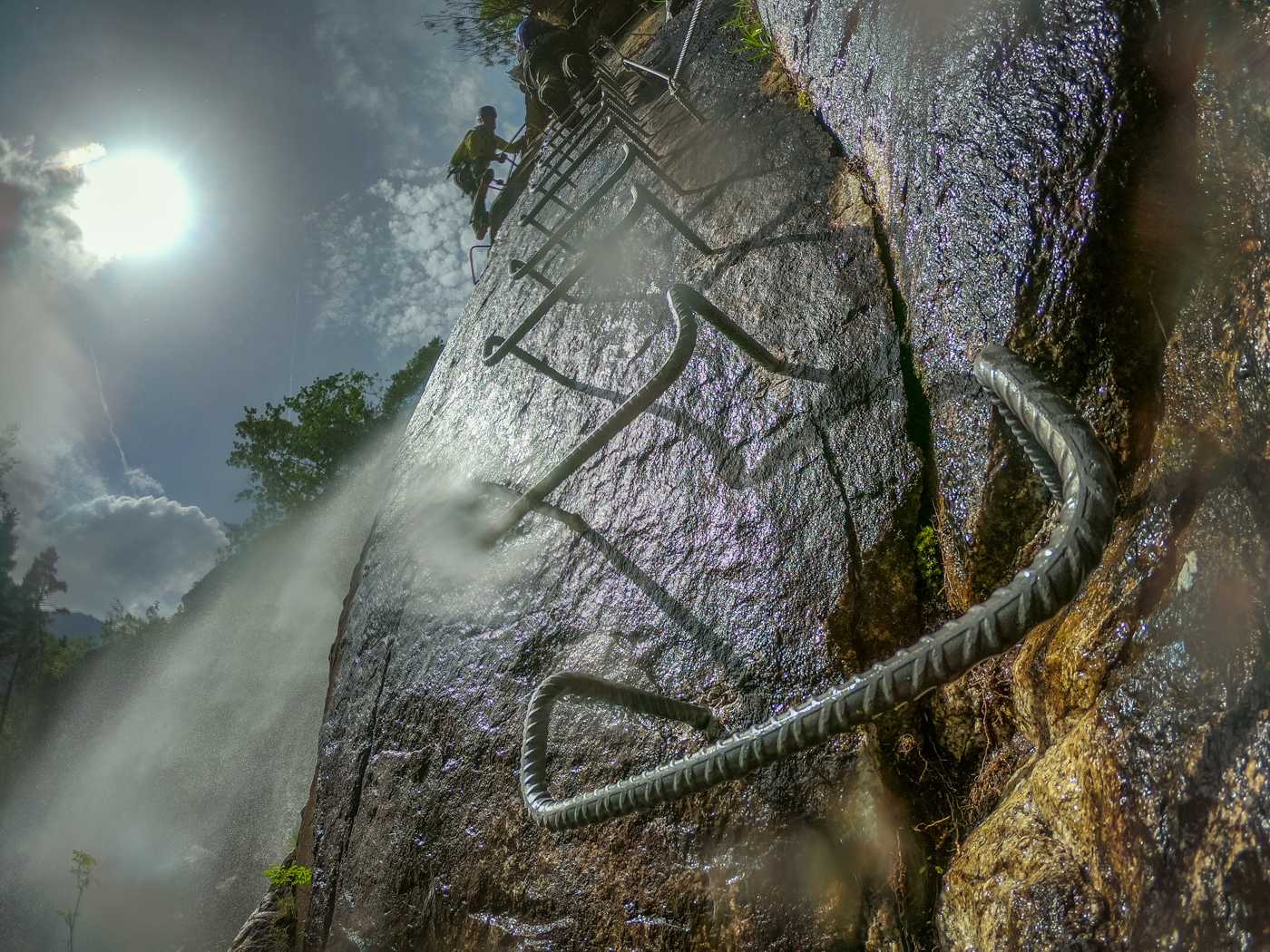 via ferrata steel steps going parallel to a waterfall